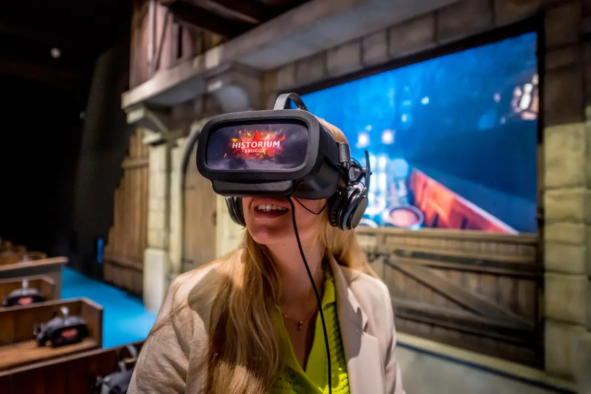 Female visitor with VR glasses sitting in the Historium Virtual Reality Experience